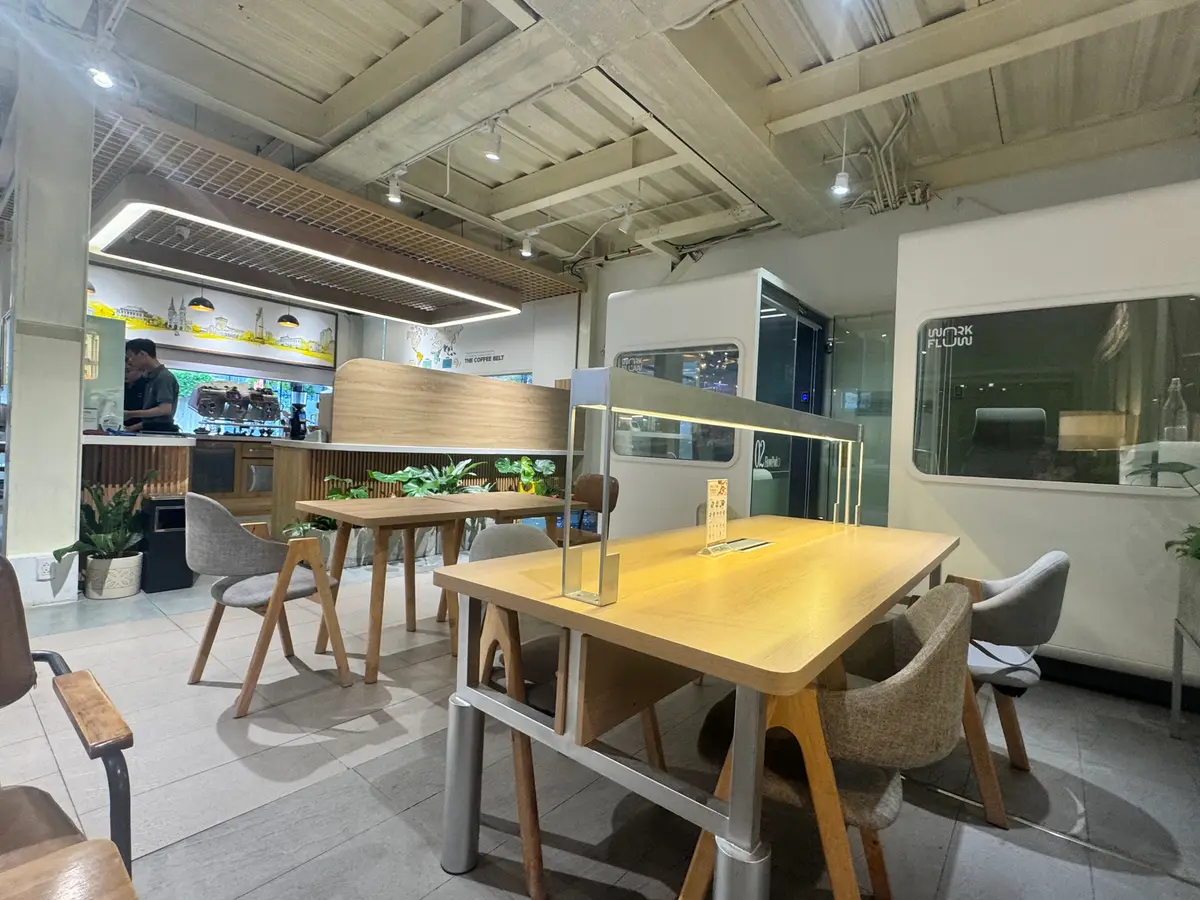 Wooden table and chairs in a bright room with a counter in the background