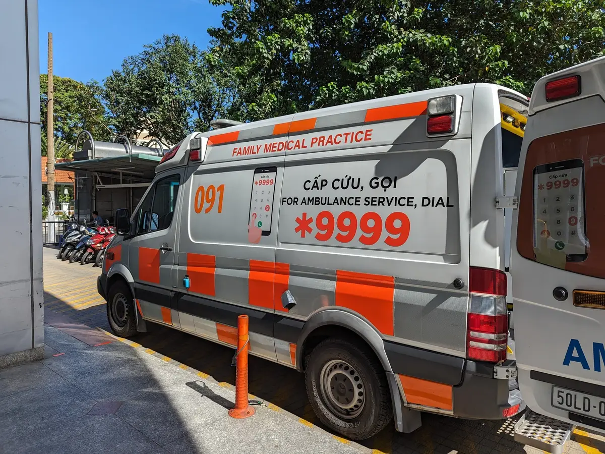 Family Medical Practice ambulance with the *9999 emergency number on its side.