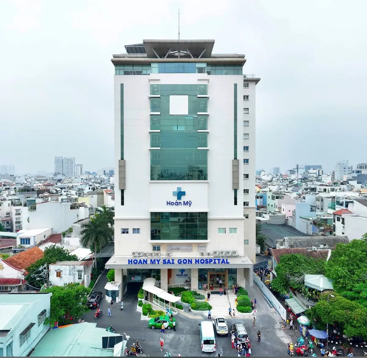 Hoan My Sai Gon Hospital tower seen from above with the hospital name on the entrance level.