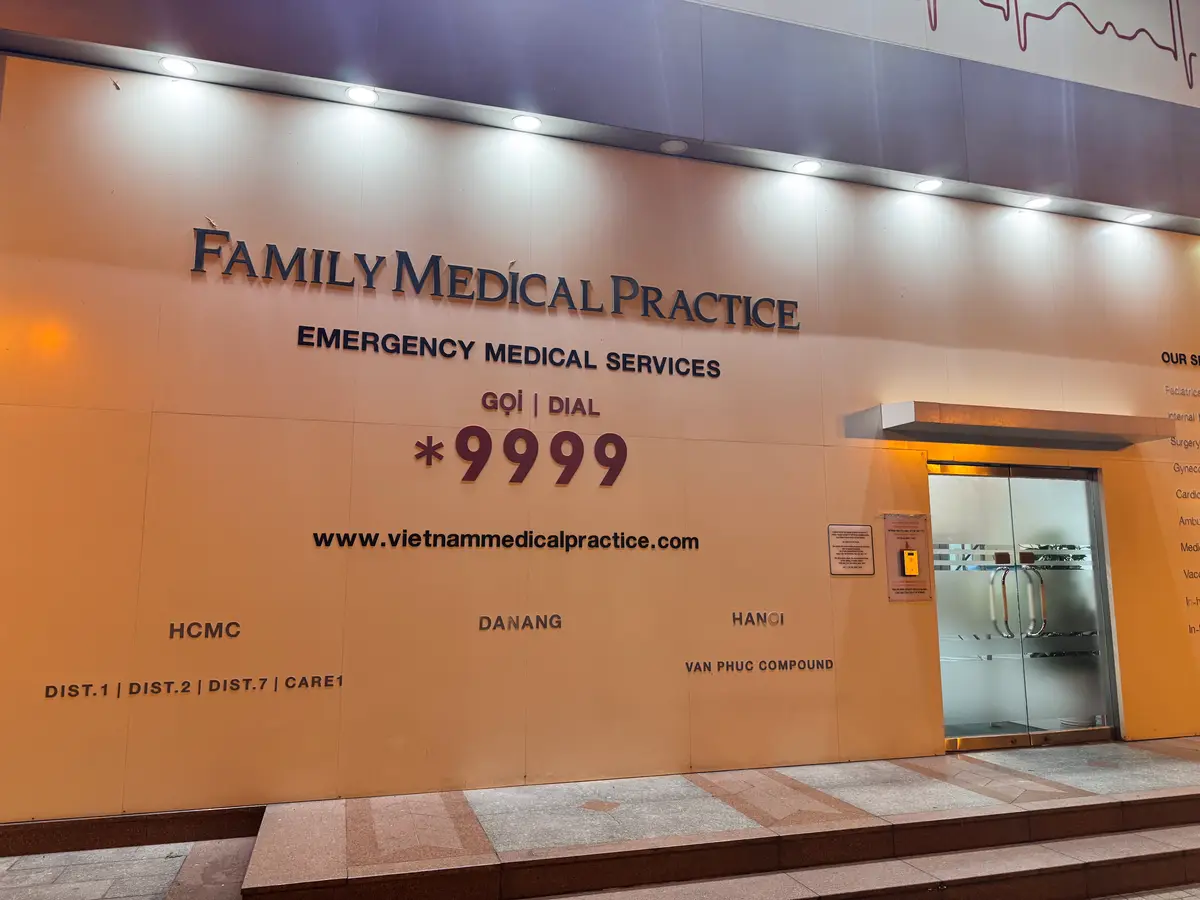 Wall sign reading Family Medical Practice, Emergency Medical Services, Dial on the clinic entrance.