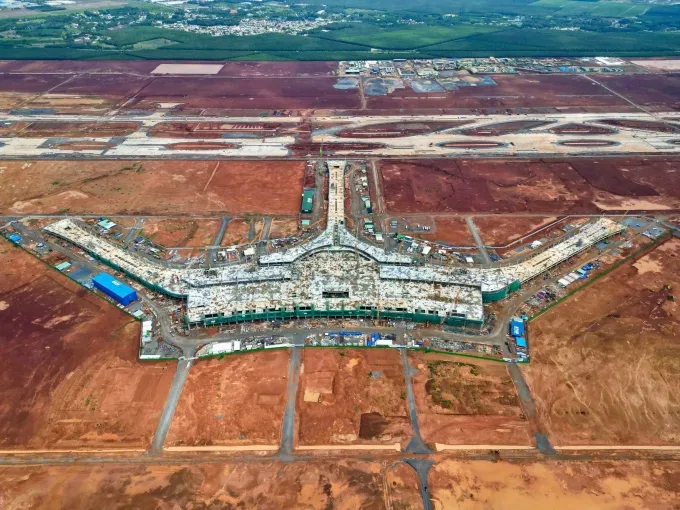 Aerial view of the terminal roof under construction with cranes and red earth around it